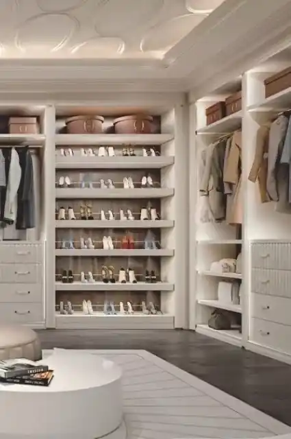 Luxury walk-in closet with a marble countertop and custom lighting.